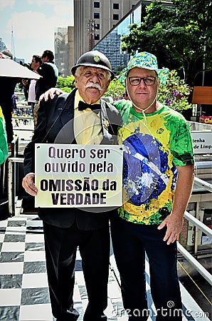 On Paulista avenue, an elderly man holds a sign that reads: `I want to be heard by omission of the truth` Editorial Stock Photo