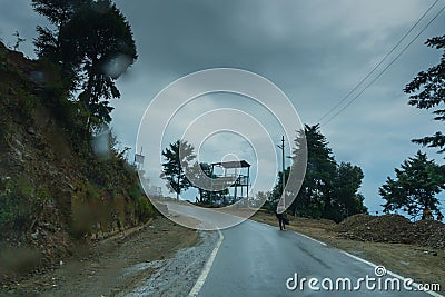 Pauri, Garhwal, Uttrakhand, India - 3rd November 2018 : Monsoon on the hilly streets of Pauri. Rainy street image of busy town on Editorial Stock Photo