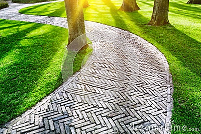 Paved footpath in spring park Stock Photo