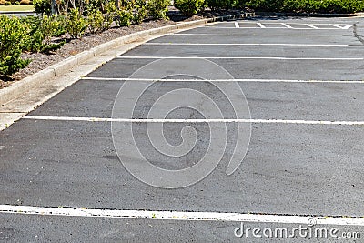 Paved and lined parking lot, asphalt with formed concrete curb Stock Photo