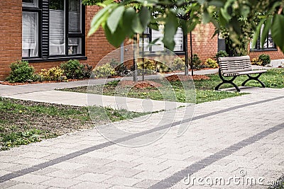 Paved path leading to a modern brick building Stock Photo