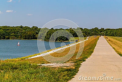 Paved path on top of a levy at Ed Zorinsky lake Stock Photo