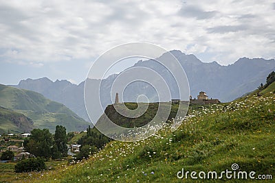 Paved road of Georgia surrounded by green high mountains. Stock Photo