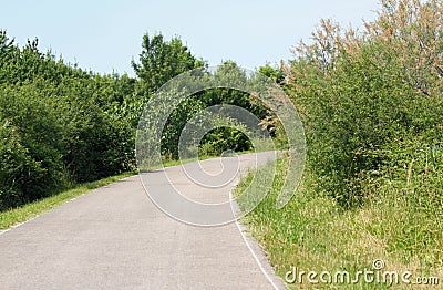 Paved road and you don't know what there is behind the curve Stock Photo