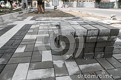 Pavement cobblestone in the stack on the street. Concrete or granite gray square pavement slabs for sidewalk Stock Photo