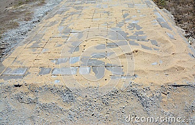 Pavers installation and covered sand for house garden pathway Stock Photo