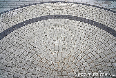 Paving stone laid in a semicircle. Well visible pattern of stones. Top view of the square from the old pavers Stock Photo