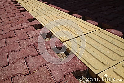 Paving tiles and blind track Stock Photo