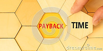 Payback time symbol. Concept words Payback time on wooden puzzles. Beautiful yellow table yellow background. Businessman hand. Stock Photo