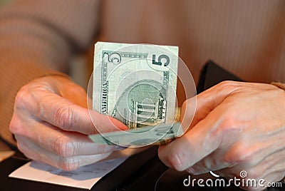 Paying The Bill With Twenty Five Dollars Stock Photo