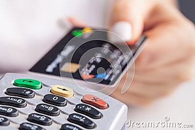 Paying with credit card. Female inserting chip card into payment terminal device Stock Photo