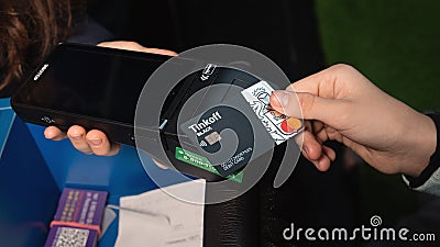 payment being made with contactless debit card with wireless technology. Omsk, Russia, December 2020 Editorial Stock Photo