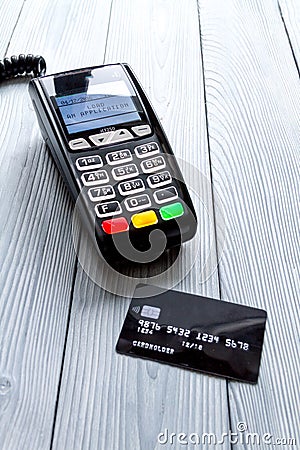 Payment card through terminal in store top view wooden background Stock Photo