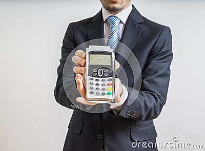 Payment with credit card. Businessman holds payment terminal in hand Stock Photo