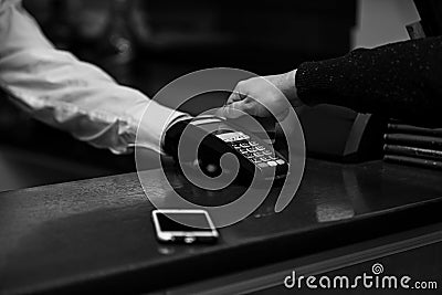 Payment with credit card. Male hand puts bankcard into reader Stock Photo