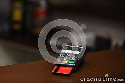 Payment with credit card. Red bankcard inserted in EDC machine Stock Photo