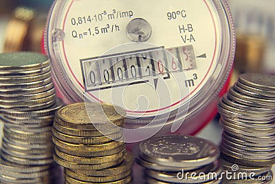 Payment for utilities. Water meter on the background of coins Stock Photo