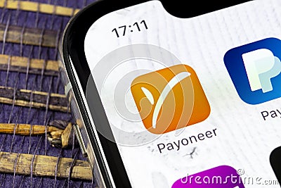 Payoneer application icon on Apple iPhone X smartphone screen close-up. Payoneer app icon. Payoneer is an online electronic financ Editorial Stock Photo