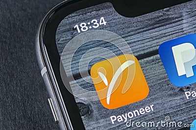 Payoneer application icon on Apple iPhone X smartphone screen close-up. Payoneer app icon. Payoneer is an online electronic Editorial Stock Photo