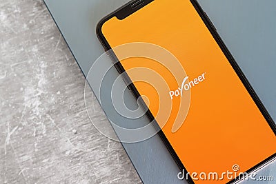 Payoneer application on on mobile phone screen. Editorial Stock Photo