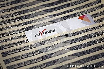 Payoneer prepaid plastic debit card on hundred dollar bills Editorial Stock Photo