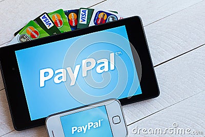 PayPal payment system logo on tablet and smartphone Editorial Stock Photo