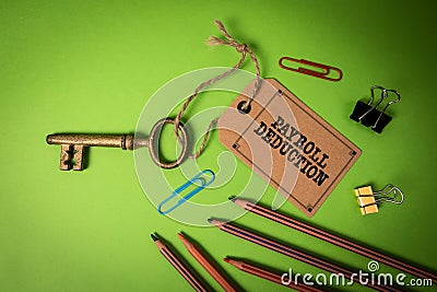 Payroll Deduction. Golden key with price tag on green office table Stock Photo