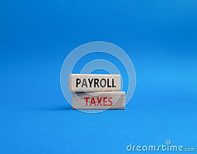 Payroll taxes symbol. Concept word Payroll taxes on wooden blocks. Beautiful blue background. Businessman hand. Business and Stock Photo