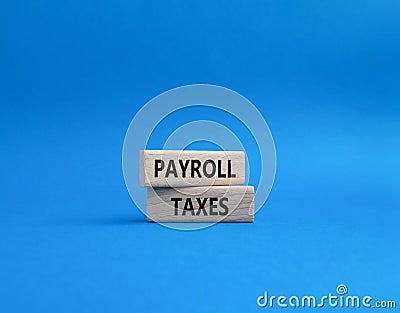 Payroll taxes symbol. Concept word Payroll taxes on wooden blocks. Beautiful blue background. Businessman hand. Business and Stock Photo