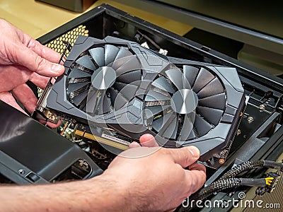 PC assembly and upgrade. Installing video card in an open case of personal computer. Graphics adapter or graphics card Stock Photo