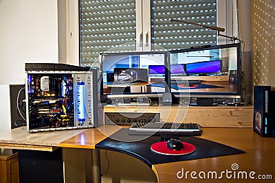 PC Personal computer with 2 flat screens, modding and picture of Editorial Stock Photo