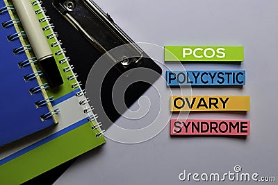 PCOS. Polycystic Ovary Syndrome write on sticky notes. Isolated on white table background Stock Photo