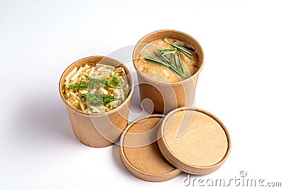 Pea and chicken soup in paper disposable cups for take-out or delivery of food on white background Stock Photo