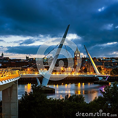 Peace bridge in Derry Londonderry in Northern Ireland with city center Editorial Stock Photo