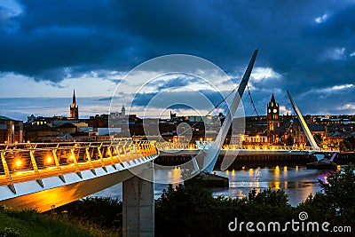 Peace bridge in Derry Londonderry in Northern Ireland with city center Editorial Stock Photo