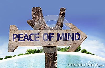 Peace of Mind wooden sign with a beach on background Stock Photo