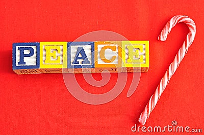 Peace spelled with Alphabet blocks on a red background Stock Photo