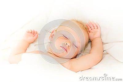 Peaceful baby lying on a bed sleeping Stock Photo