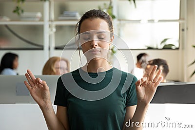 Peaceful calm millennial office employee keeping hand zen gesture Stock Photo