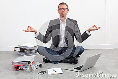 Peaceful entrepreneur practicing yoga on the office floor Stock Photo