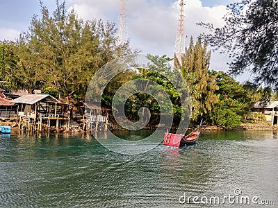 A Peaceful Fishing Boat On The Riverside Stock Photo