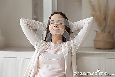 Peaceful girl with closed eyes resting on comfortable couch Stock Photo