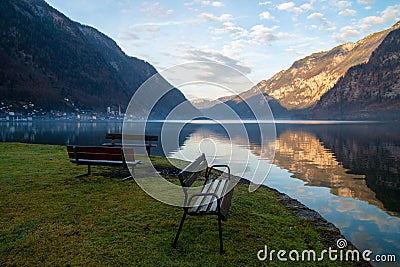 Peaceful landscape with park benches in front of calm lake, Hallstatt mountains village in Austria Stock Photo