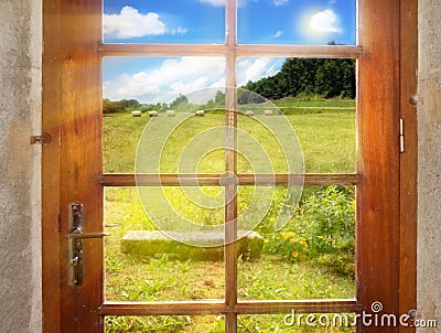 A peaceful rural landscape outside the rustic-style doors Stock Photo