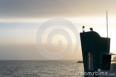 Peaceful and simple view over Mediterranean sea water and silhouette of a modern building in first plan Stock Photo