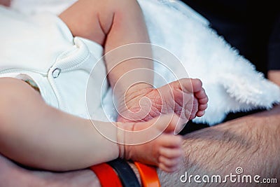 Peaceful sweet newborn infant baby feet lying in mother hands Stock Photo