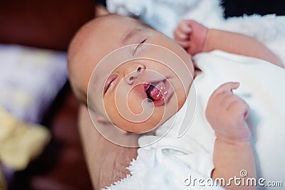 Peaceful sweet newborn infant baby lying on bed while sleeping in a bright room Stock Photo