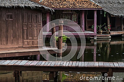 Peaceful thai floating architecture with traditional wooden house and bridge in Ancient City Stock Photo