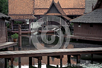 Peaceful thai floating architecture with traditional wooden house and bridge in Ancient City Stock Photo