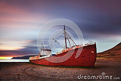 Peaceful view of the Atlantic ocean at dawn. ship wreck in the Iceland, Europe. Scenic image of beautiful nature landscape. Stock Photo